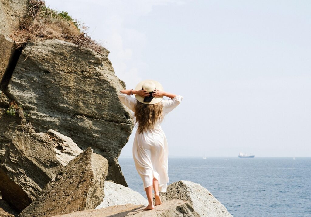 woman roaming beachside cliffs - the midnight feast book review